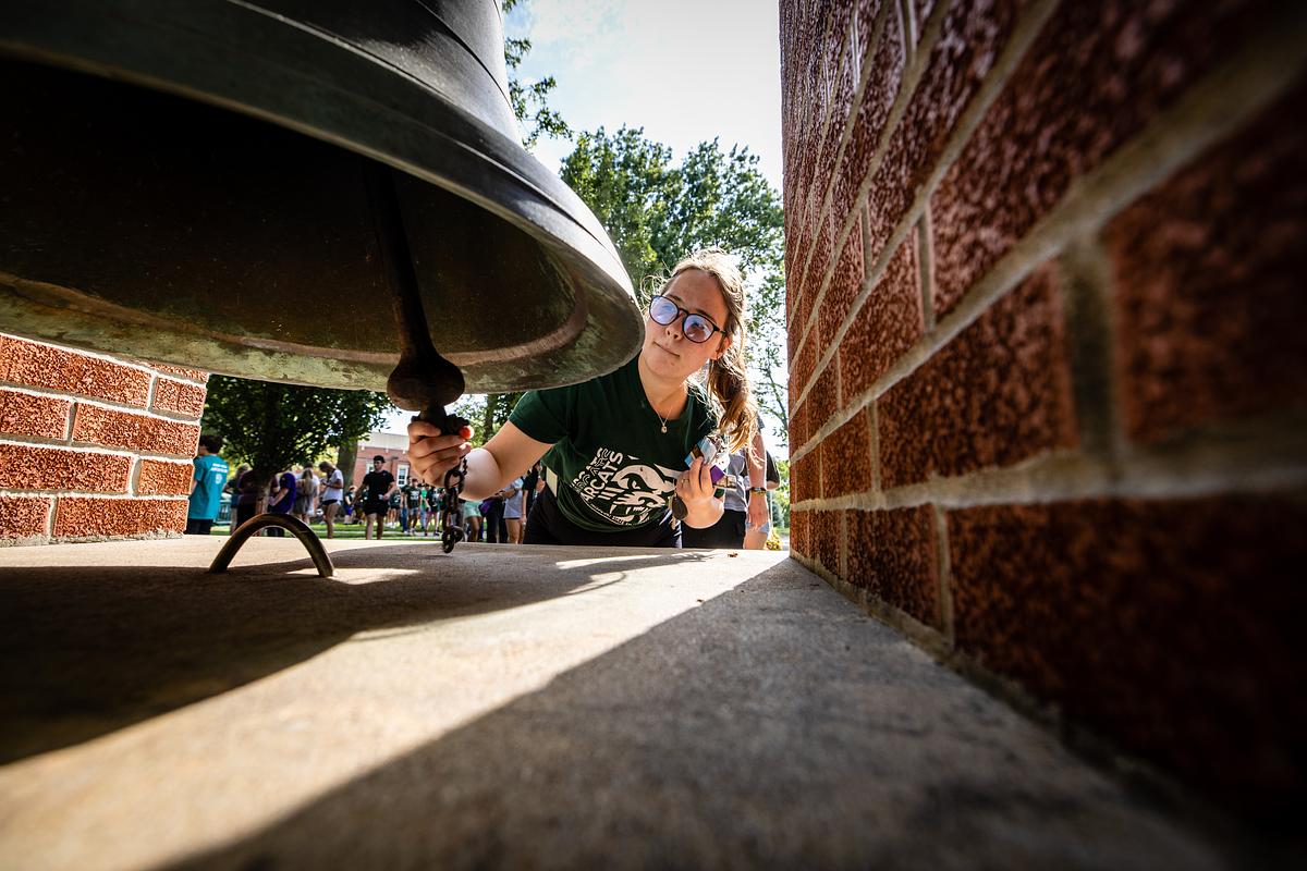 A new student rings the Bell of '48 during New Student Celebration