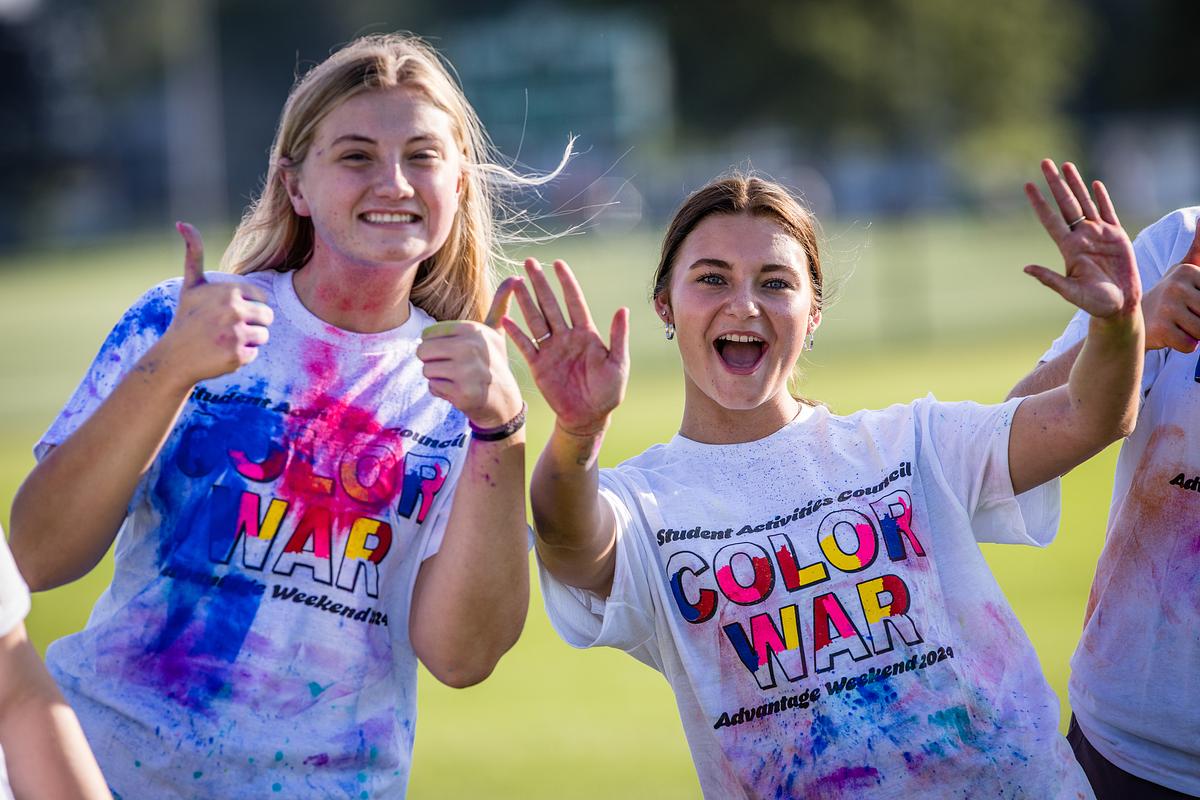 A student gives two thumbs up during the Color games
