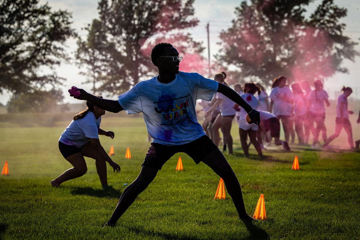 A student prepares to show a powder paint ball during the Color games