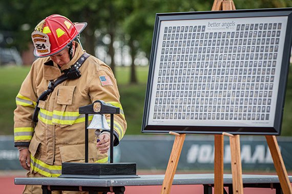 Maryville firefighters annually participate in a bell ringing ceremony to commemorate 9/11 victims before the stair climb begins. (Chandu Ravi Krishna | Northwest Missouri State University)