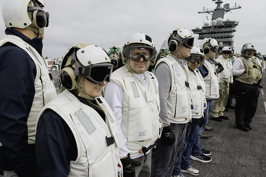 Northwest President Dr. Lance Tatum (center) observed flight operations on the USS George Washington flight deck and interacted with its sailors.