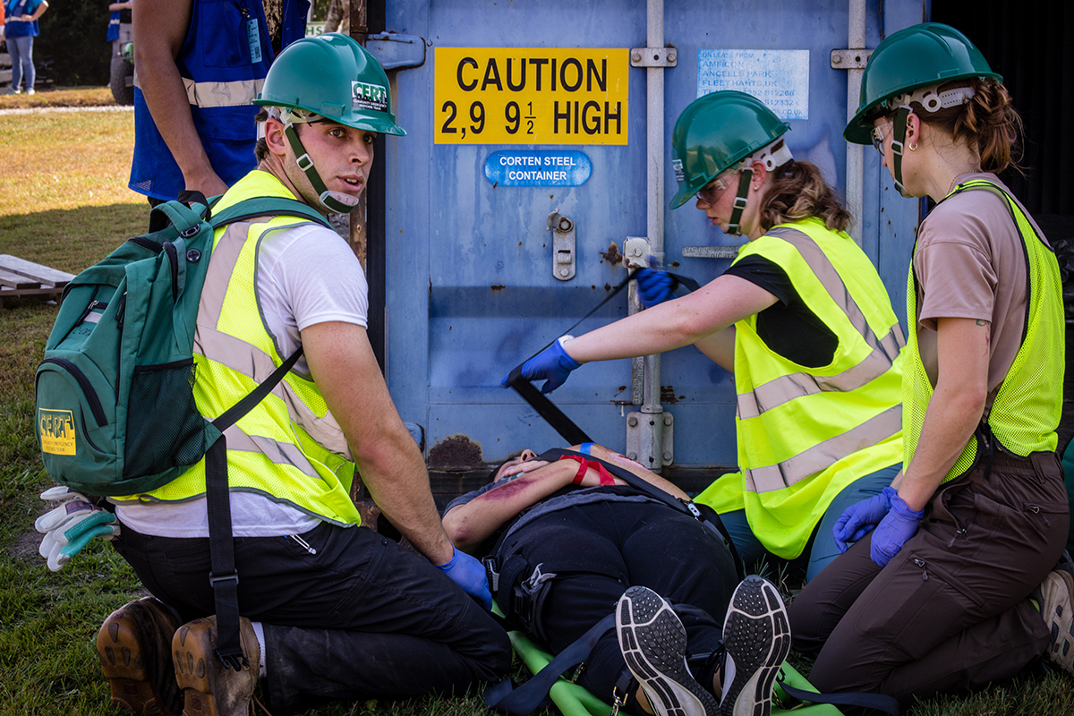 First responders tend to a person playing the role of a victim during Northwest's annual Missouri Hope emergency response field training exercise. (Photos by Lilly Cook/Northwest Missouri State University)
