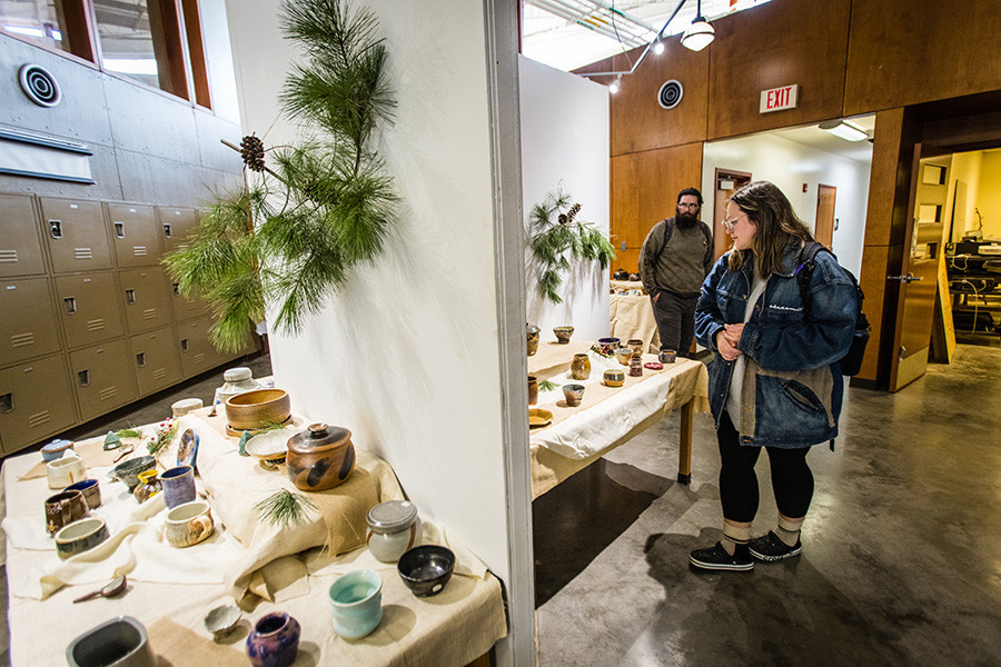 Patrons take in some of the ceramic work at a previous  art show and sale at Northwest. (Photo by Lauren Adams/Northwest Missouri State University)