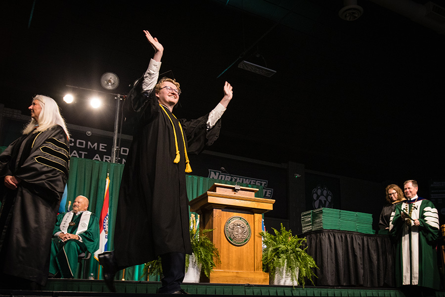 A Northwest student raises his arms in celebration during a commencement ceremony last spring. The University will host its winter commencement ceremonies on Dec. 13. (Photo by Lauren Adams/Northwest Missouri State University)