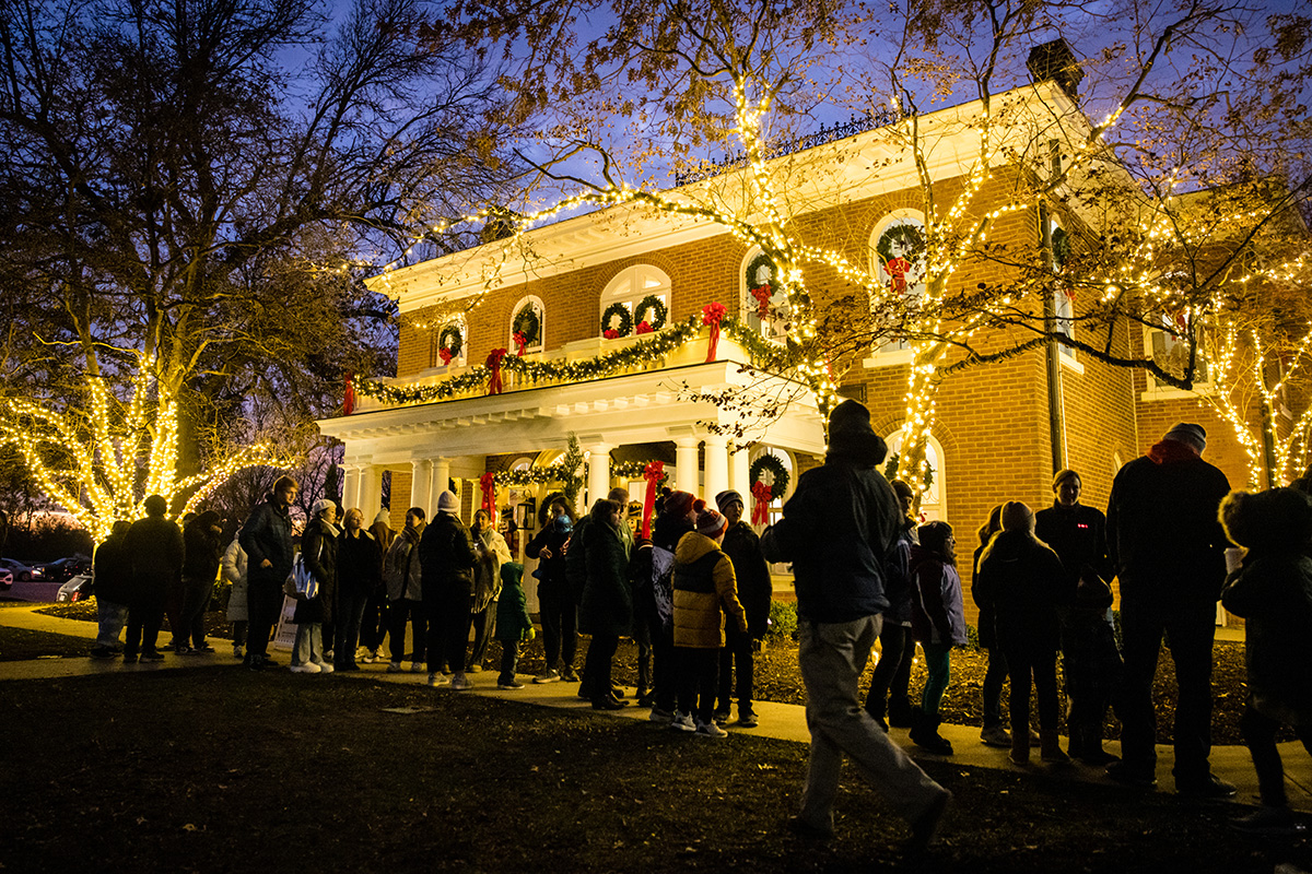 The historic Thomas Gaunt House on the Northwest campus lights the crowd gathered for the annual President’s Tree Lighting. (Photo by Lilly Cook/Northwest Missouri State University)