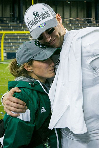 Kelly Quinlin gets a hug from a Bearcat football player after Northwest won the 2015 NCAA Division II national championship. (Northwest Missouri State University photo)