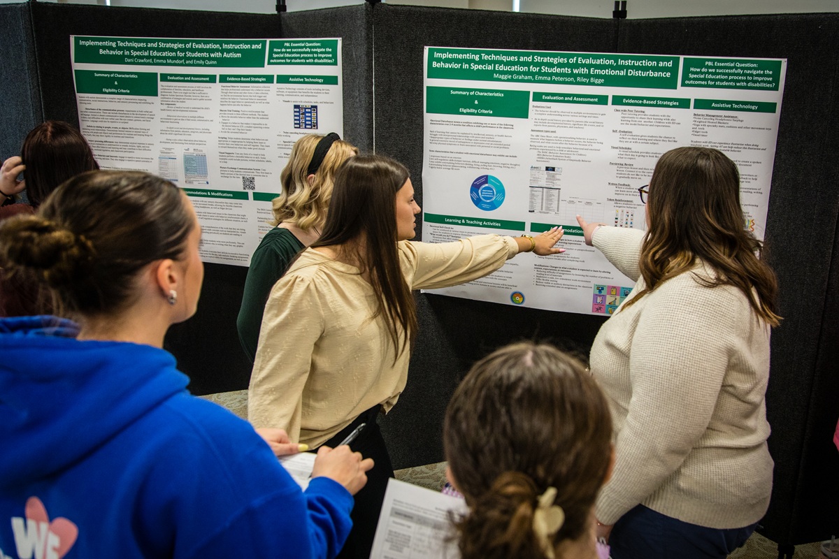 Students discuss research of instruction and behavior in special education during a poster presentation at Northwest's annual Celebration of Scholars. (Photo by Maria Nino-Elliott/Northwest Missouri State University)
