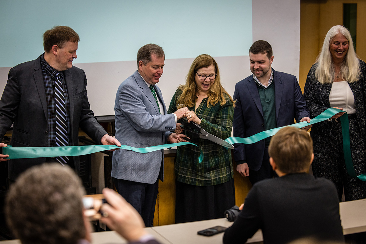 Left to right, Dr. Ben Blackford, the director of Northwest's Booth School of Business; Northwest President Dr. Lance Tatum; Angela Moskow, the daughter of Melvin D. and Valorie G. Booth; Bobby Moskow, the grandson of Melvin D. and Valorie G. Booth; and Northwest Provost Dr. Jamie Hooyman; cut a ribbon commemorating the opening of the business school's Finance Trading Room. (Photo by Lilly Cook/Northwest Missouri State University)