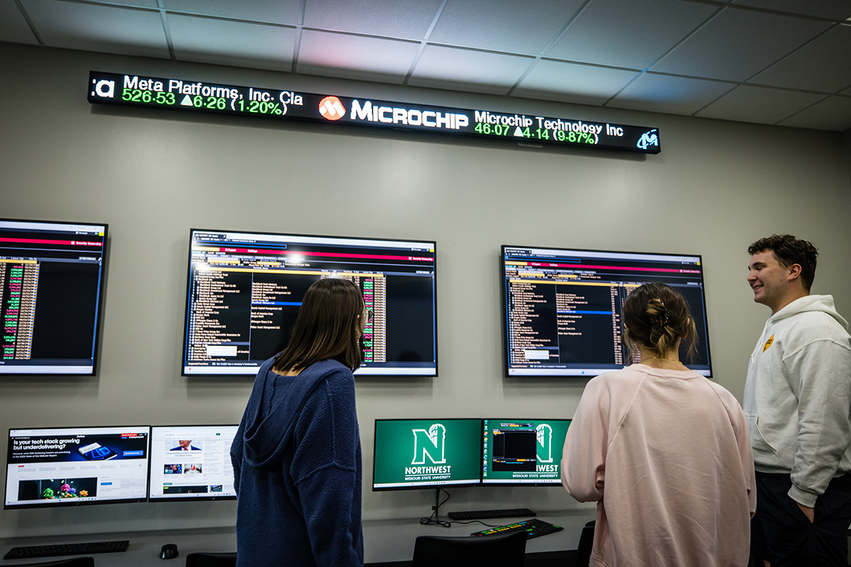 Northwest students take a look at the new Finance Trading Room in Colden Hall after a ribbon-cutting ceremony on Thursday. (Photo by Lilly Cook/Northwest Missouri State University)