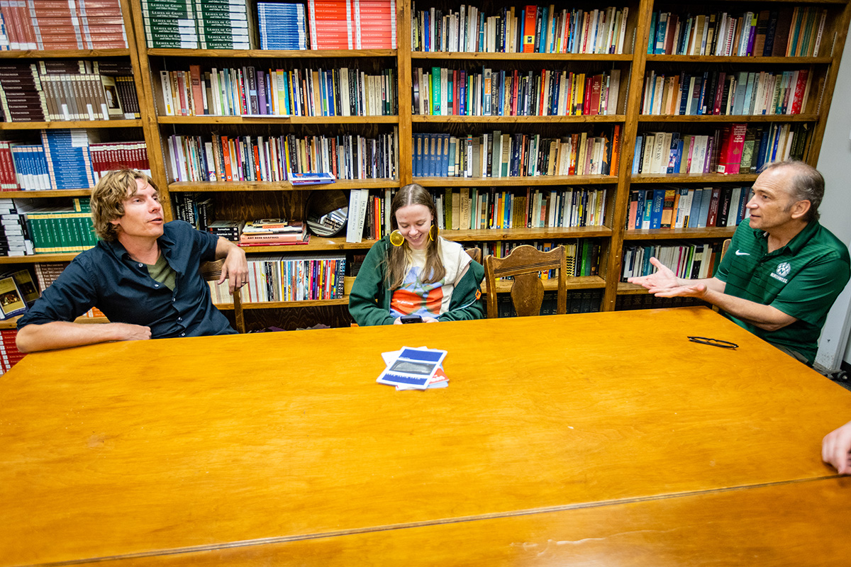Dr. John Gallaher (right) talks with Assistant Professor Luke Rolfes (left) and students in the office of The Laurel Review. (Photo by Todd Weddle/Northwest Missouri State University)