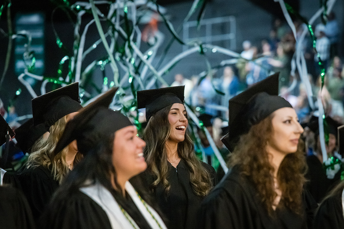 Northwest graduates reacted as green and white streamers fell over them at the conclusion of a commencement ceremony Saturday morning. (Photo by Todd Weddle/Northwest Missouri State University)