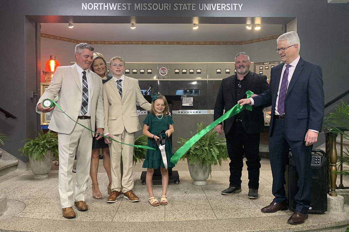 Sharon Cross Bonnett's family cut a ribbon commemorating the renaming of KXCV's studio in Wells Hall to the Sharon Cross Bonnett Studio. Left to right are Cross Bonnett's son, Tim Shipley, with his wife, Nan; son, Renner; and daughter, Evve; with Cross Bonnett's son, Aaron, and KXCV-KRNW Director and Station Manager John Coffey. (Northwest Missouri State University photo)