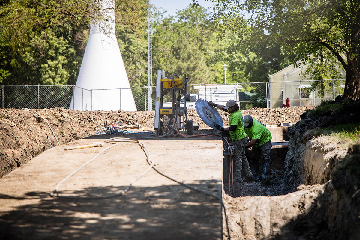 Construction workers are pictured outside one of Northwest's steam tunnels as work progresses this summer on the University's infrastructure modernization project. (Photo by Lilly Cook/Northwest Missouri State University)