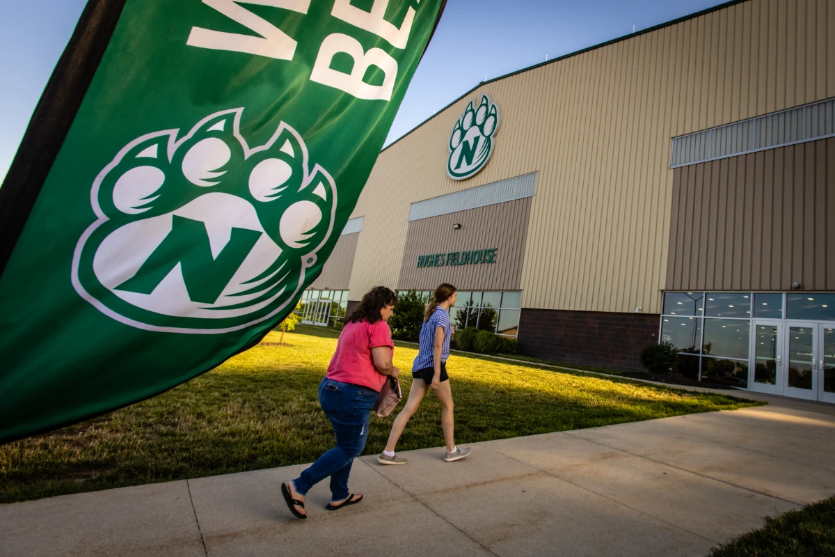A student and a parent enter Hughes Fieldhouse to check in for SOAR.