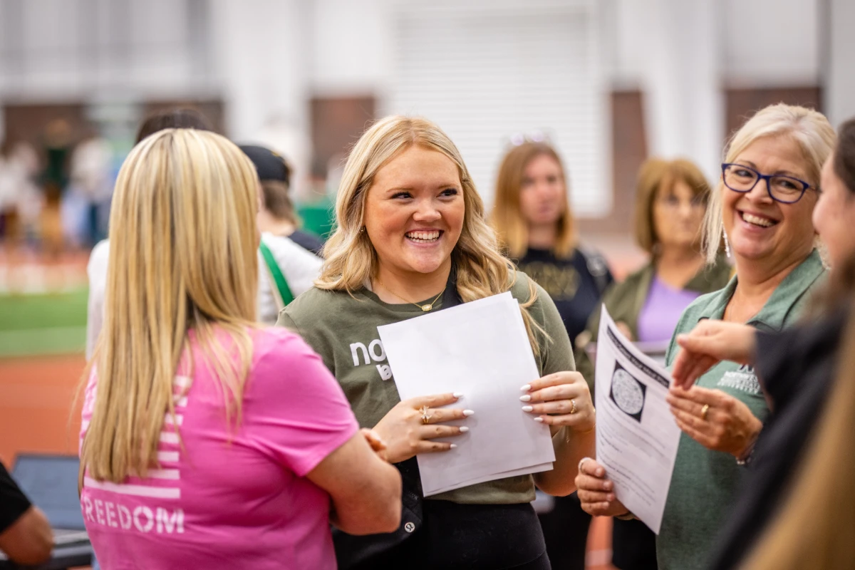 A student consults with residential life to learn what items they need to bring to college in August.